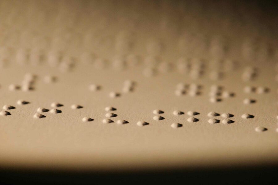 Braille text on paper representing accessible document formats and Section 508 compliance standards